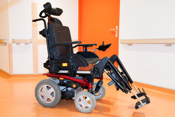 disabled electric chair empty in corridor hospital wheelchair indoors