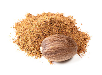 pile of whole nutmeg seed and powder on white