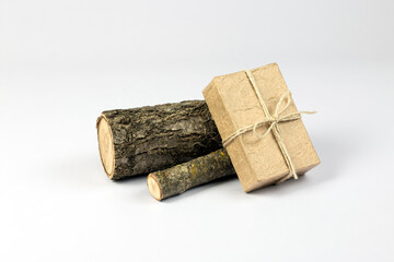 Craft paper gift box and wooden logs isolated on white background. Handmade gift concept. Part of set.