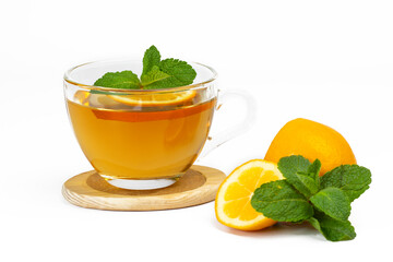 Transparent glass cup with aromatic tea, mint leaves and lemon slice isolated on white background. Part of set.
