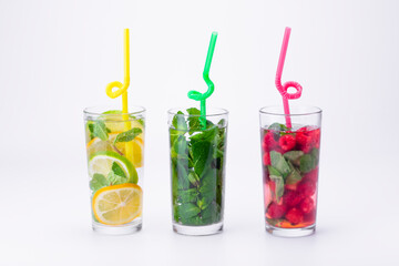 Cocktails isolated on white background. Lemon and lime, mint and raspberries cocktails.