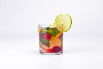 Cocktail isolated on white background. Lemon and lime, mint and raspberries cocktail.