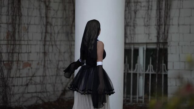 depraved nun is walking outdoors, extravagant artistic shot, medium portrait