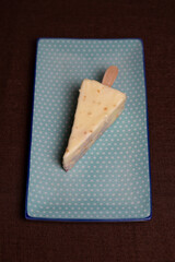 triangular dessert on a stick in white chocolate