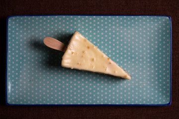 top view triangular dessert on a stick in white chocolate