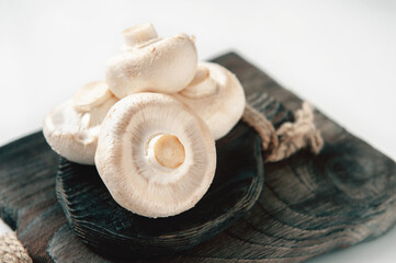 natural, organic mushrooms on a vintage wooden table. Fresh Raw Porcini Mushrooms On A Wooden Cutting Board, Isolated On A White Background, Side View