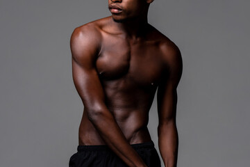Fototapeta na wymiar Shirtless lean young African man body in studio isolated gray background