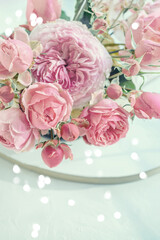 beautiful banner with a delicate bouquet of pink peony roses and bokeh hearts. Copy space