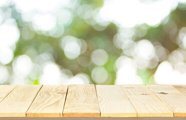 wood floor with blurred trees of nature park background and summer season, product display montage