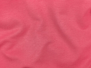 Pink jersey fabric matte texture top view. Red coral knitwear satin background. Fashion color feminine clothes trend. Female blog backdrop text sign design. Girly abstract wallpaper textile surface.