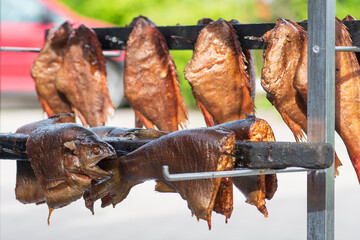 Naklejka premium Various dry smoked spiced salmon or trout fish ready to eat in a fish market