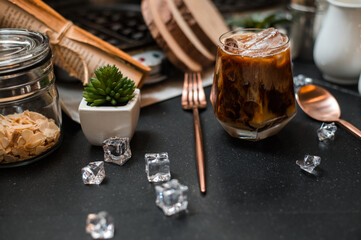 Close-up of iced coffee served on black table at cafe​