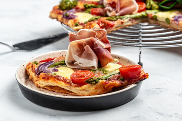 tart with asparagus, bacon, spinach, cherry tomatoes and cheese. Ketogenic paleo diet. place for text, top view