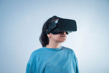 young woman working with vr headset device, moving virtual object with his hands. using new technology at work and having fun