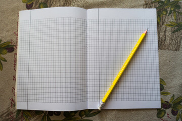 yellow pencil on a notebook