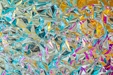 Bright young juicy chrome bold crumpled texture foil with gradient color of magenta and yellow....