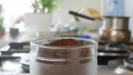 Making a Tasty Fresh Coffee with a Teaspoon of Freshly Ground Coffee. Morning Breakfast with Flavored Coffee Made in the Kitchen.