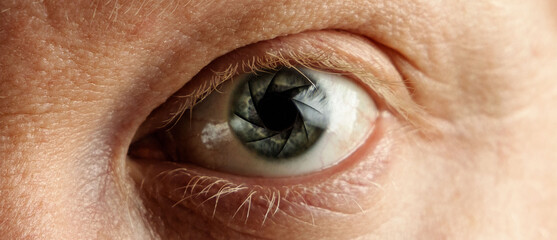 Fototapeta premium Isolated close-up of nice man eyes blue camera aperture
