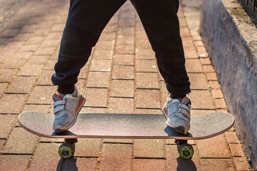 legs on skateboard close up on the street