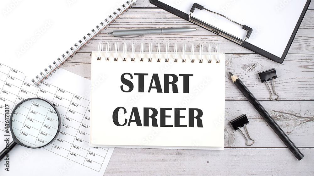Poster notepad with text start career with a pen,office tools and graphs on the desktop.