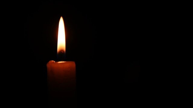 Burning Candle is an incredible stock video that displays footage of a burning candle on a black background with a copytext space. 