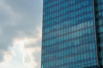 Fototapeta na wymiar Modern skyscraper facade close-up with sky