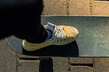 leg on skateboard close up on the street