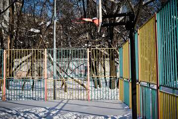 Fototapeta na wymiar Basketball playground outdoor covered by snow in winter cold