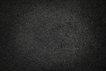 Surface grunge rough of asphalt, Grey grainy road lit in the center and shadows edges, Texture background with vignette, Top view