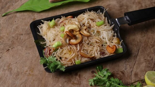 Semiya Upma or Vermicelli Uppuma or Bihun Goreng served in a bowl with top view. Fried Rice Vermicelli
