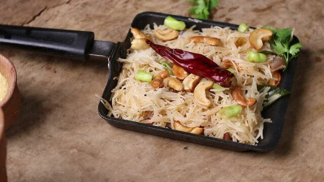 Semiya Upma or uppittu is a popular breakfast menu from south India. served in a bowl on wooden plate.