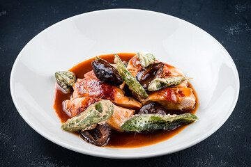 Close up Tasty chicken steaks with sage and garlic sauce closeup on a plate on the table