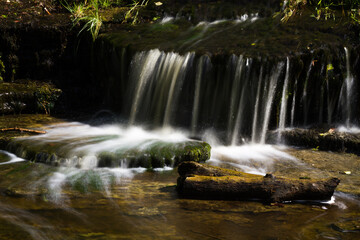Naklejka premium Cascading waterfall cascades in Estonia in green light at summertime