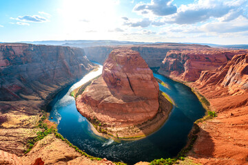 Panorama of Horseshoe Bend in Page, Arizona. The Colorado River and a land mass made of orange sandstone