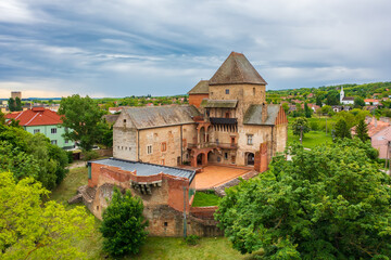 Fototapeta na wymiar Aerial panoramic view about Castle of Simontornya with cloudy sky at the background.