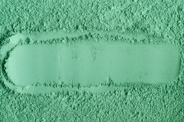Green cosmetic clay powder (kelp facial mask, spirulina body wrap) texture close up, selective...