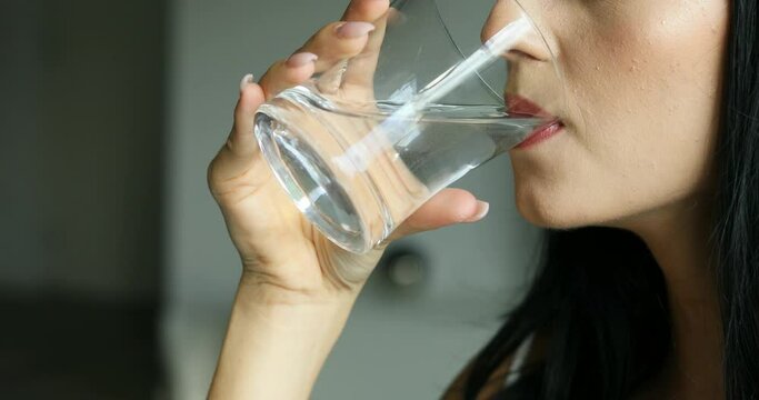 young woman drinking a glass of water