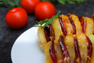 potato stuffed with salami, cheese, ketchup, garlic and herbs. Baked whole potatoes is sliced and stuffed