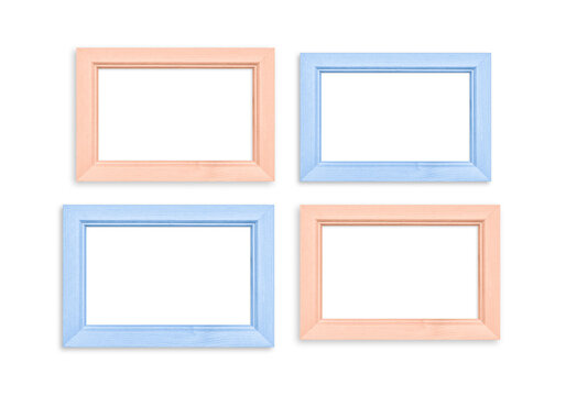 Set of colorful photo frames, four blank frameworks isolated on white wall