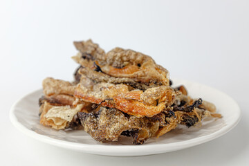 Deep-fried yellow pollack peel on a white background
