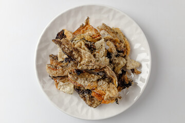 Deep-fried yellow pollack peel on a white background