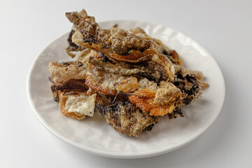 Deep-fried yellow pollack peel on a white background