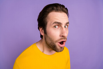 Portrait of attractive curious suspicious worried man peeking staring isolated over pastel violet...