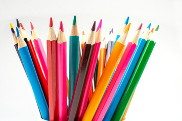 stack of wooden colored crayons on white background