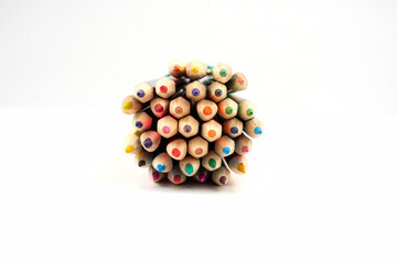stack of wooden colored crayons on white background