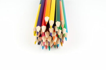 stack of wooden colored crayons on white background
