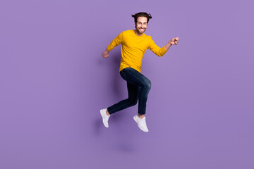 Fototapeta na wymiar Full length body size photo smiling man jumping up running fast isolated pastel purple color background