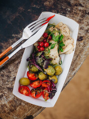 Grilled bbq squid with olives cherry and micro greens