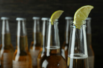 Beer with lime on wooden background, close up