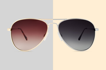 sunglasses golden and silver metallic frame and brown and gray polarized lenses isolated on beige...